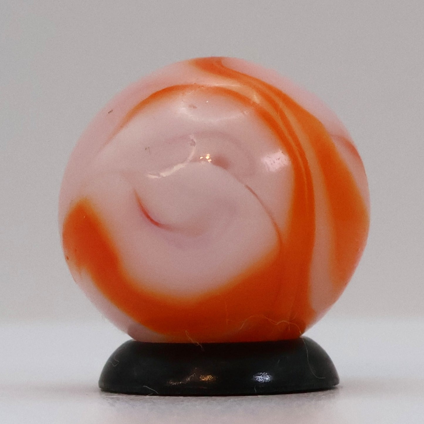 5/8" Swirl Marble orange & white, translucent base NM+