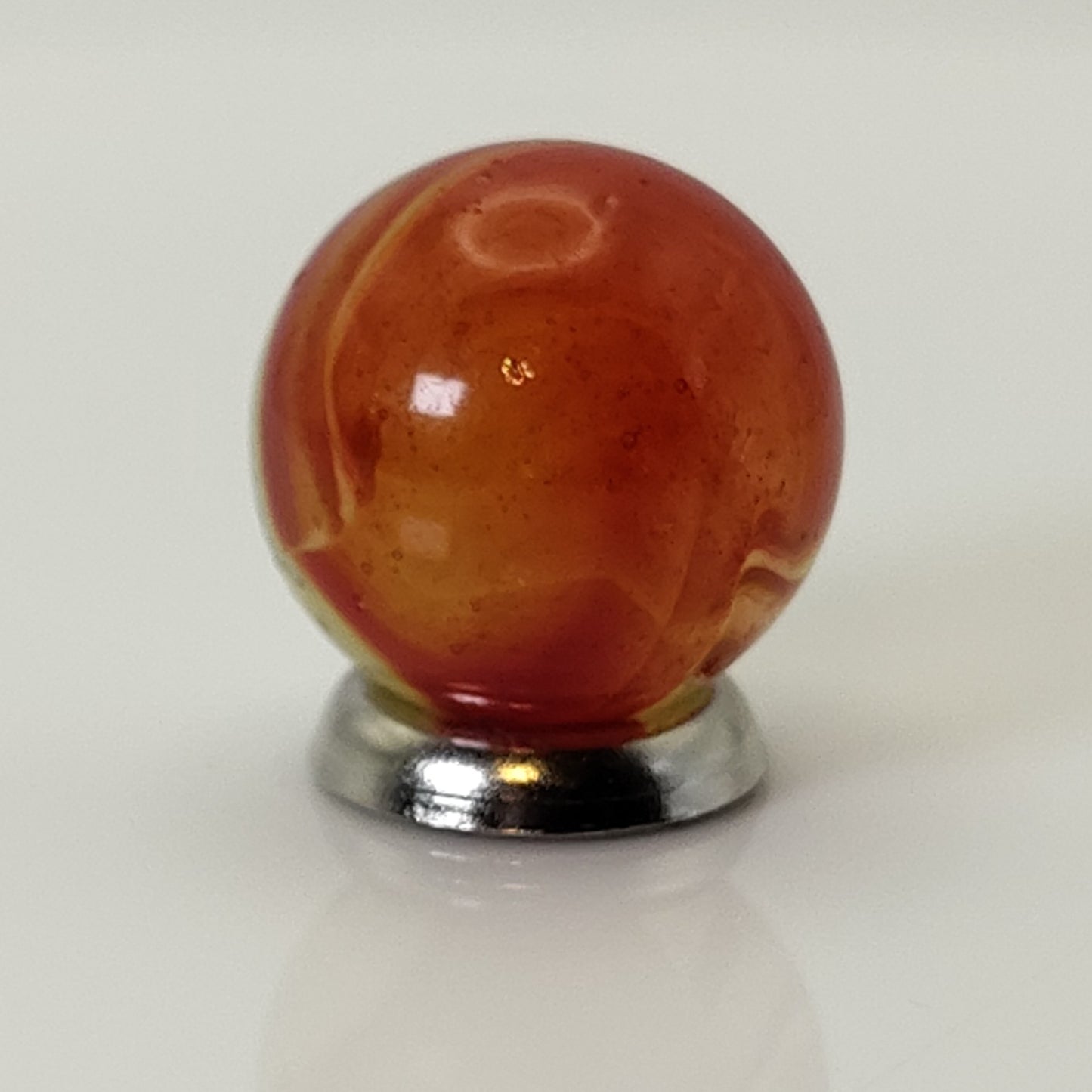 5/8" Peltier Rainbo Marble orange ribbons on Translucent Yellow UV NM
