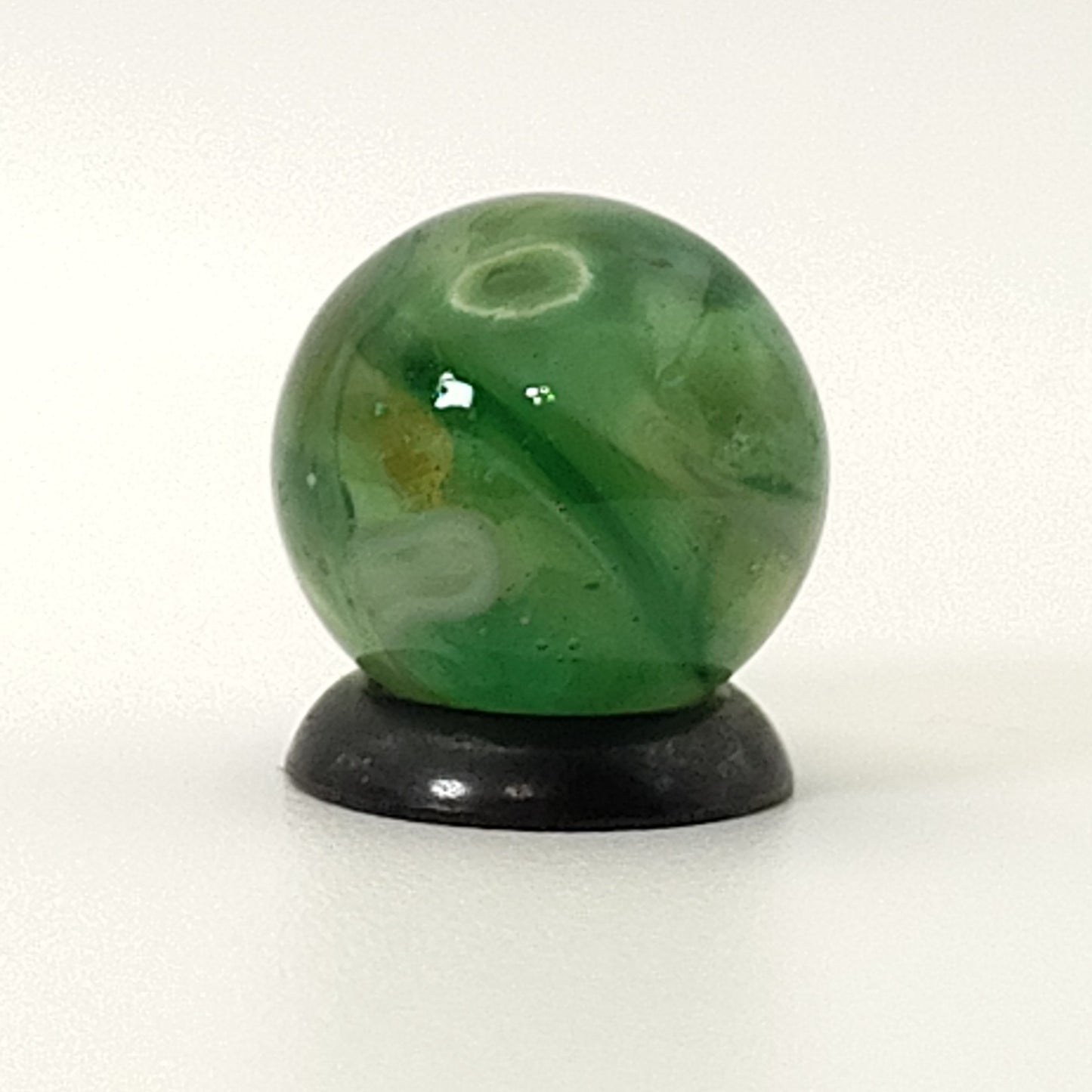 9/16" Swirl Marble green transparent base w/white & tan ribbons great backlit NM