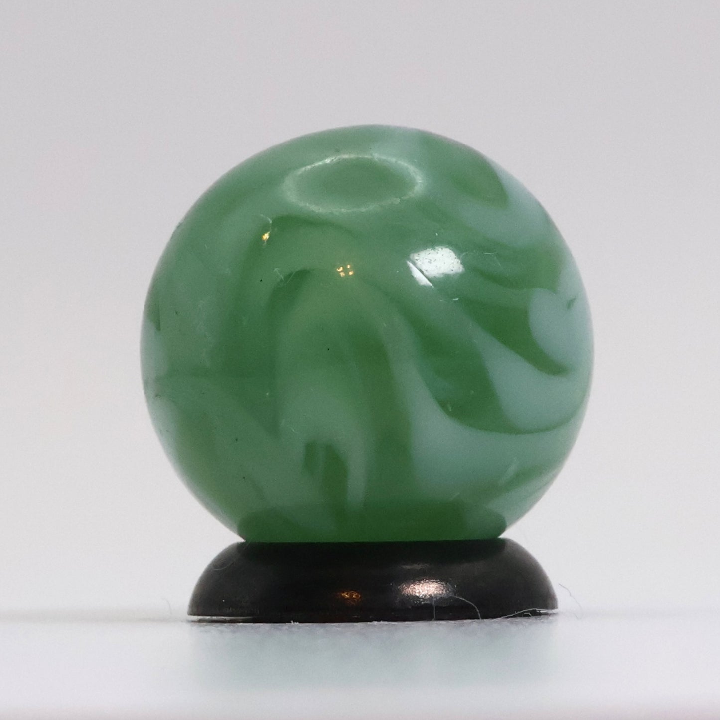 5/8" Translucent Green Marble with white ribbons busy pattern NM