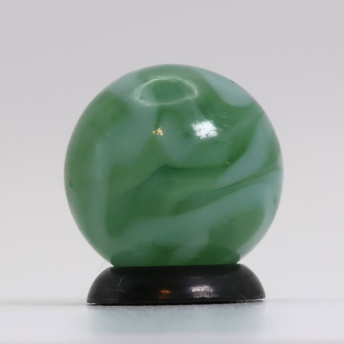 5/8" Translucent Green Marble with white ribbons busy pattern NM