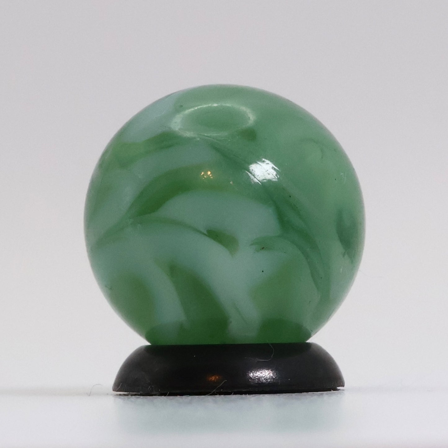 5/8" Translucent Green Marble with white ribbons busy pattern NM