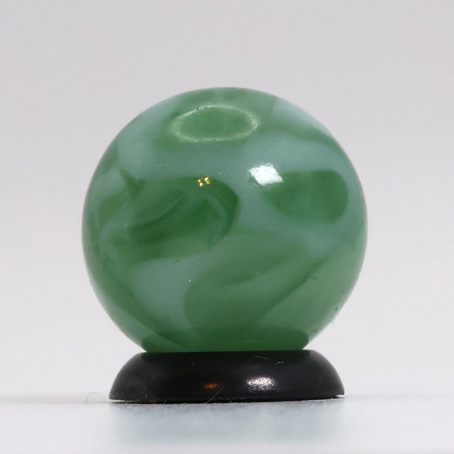 5/8" Translucent Green Marble with white ribbons busy pattern NM