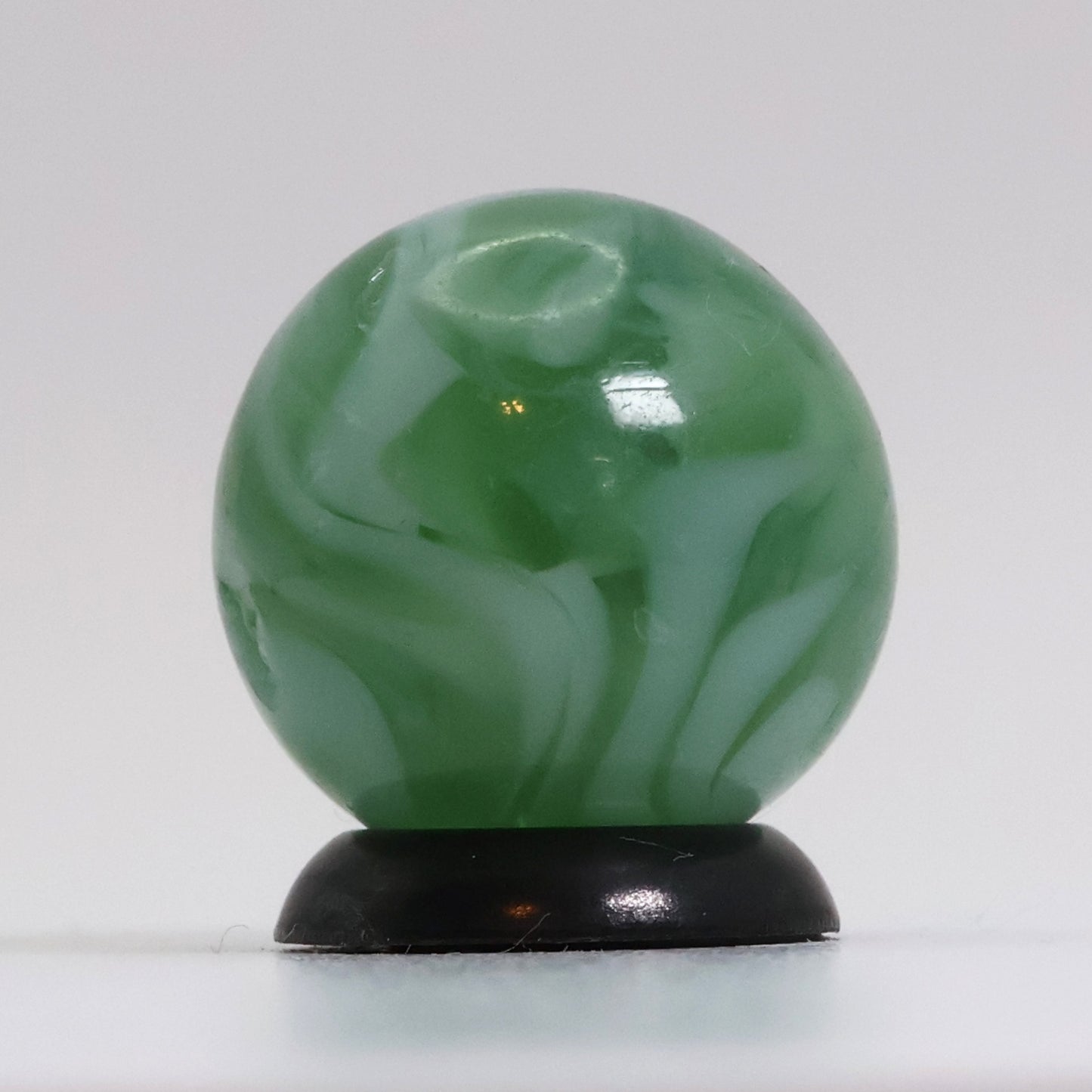 5/8" Translucent Green Marble with white ribbons busy pattern NM