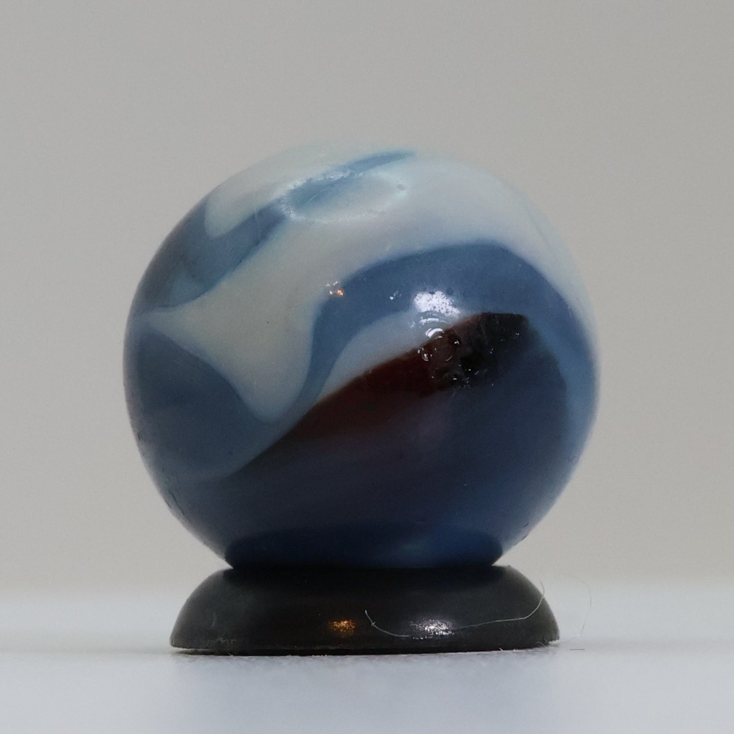 5/8" Swirl Marble Translucent Red base with blue & white Ribbons UV NM-