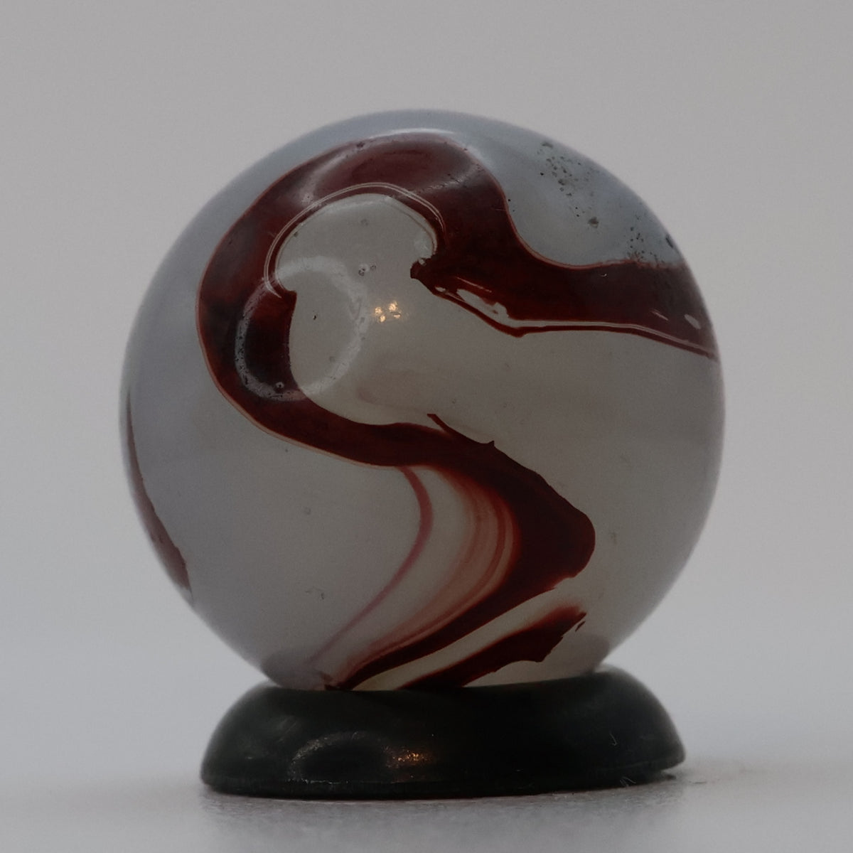 ⅝” Akro Agate Silver Oxblood NM (small pin pricks and one bigger hit)
