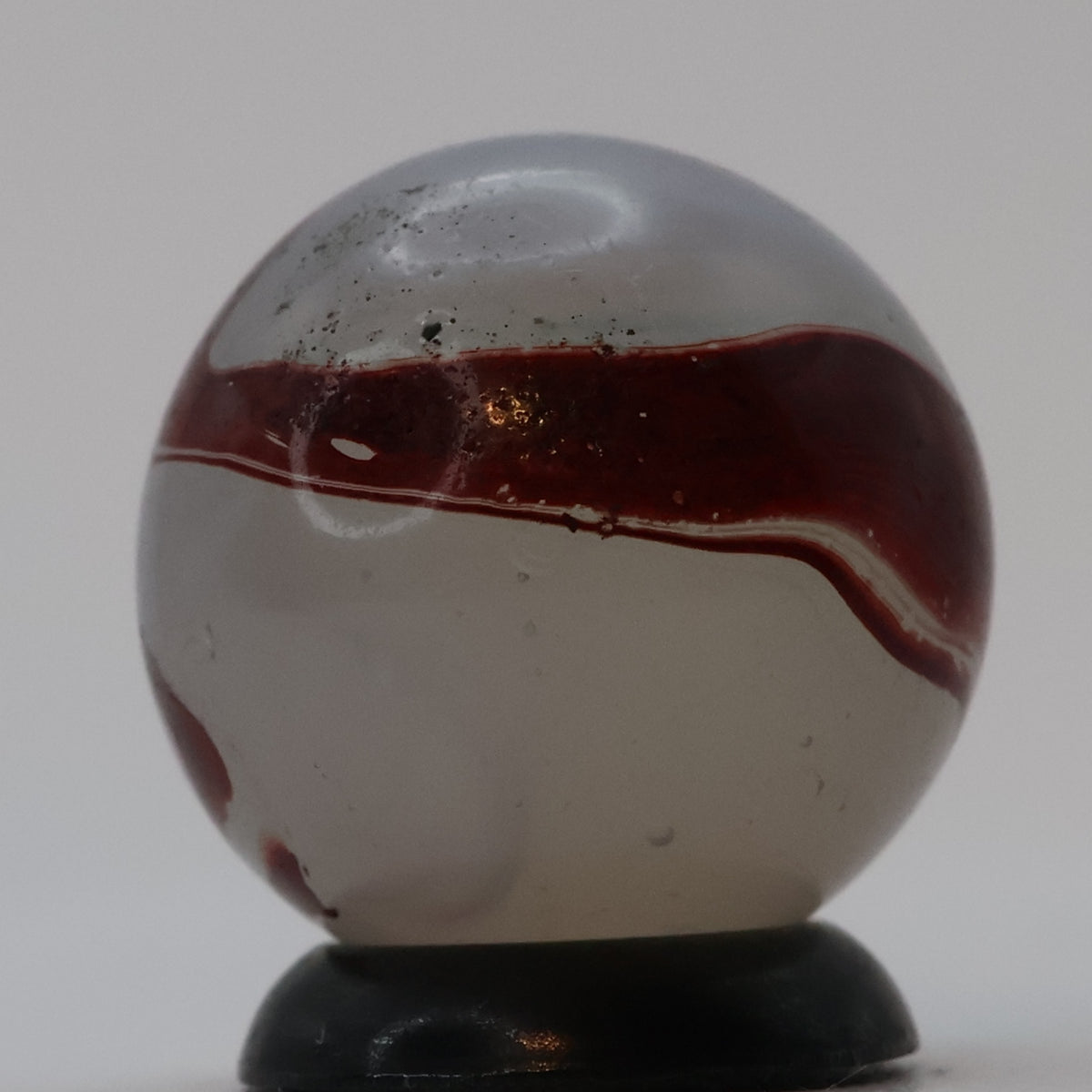 ⅝” Akro Agate Silver Oxblood NM (small pin pricks and one bigger hit)