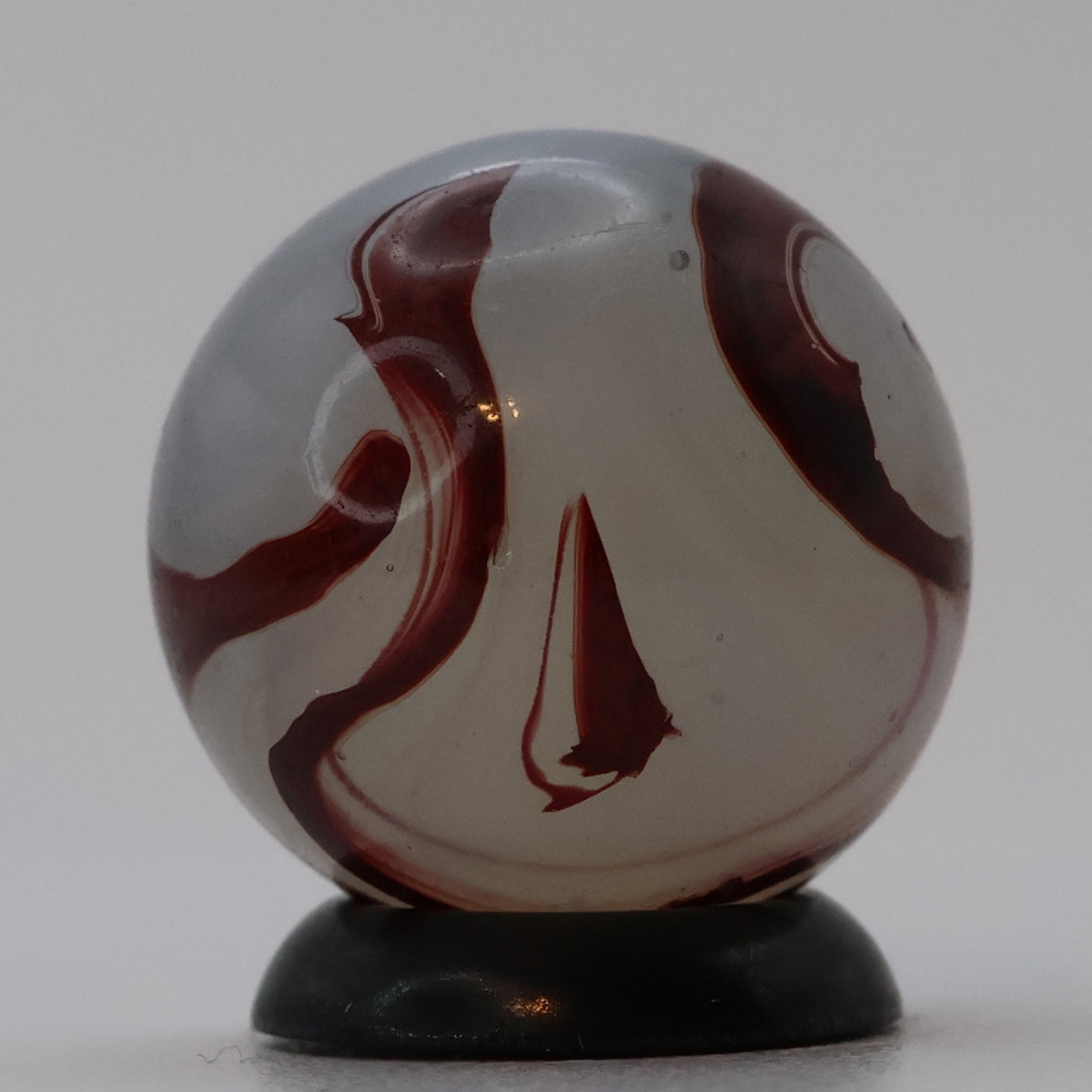 ⅝” Akro Agate Silver Oxblood NM (small pin pricks and one bigger hit)